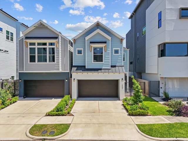 view of front of property featuring an attached garage, concrete driveway, fence, and a standing seam roof