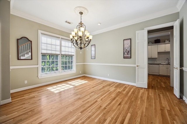 3388 Maroneal St, Houston, TX 77025 - spare room featuring a sink, a chandelier, light wood finished floors, crown molding, and baseboards