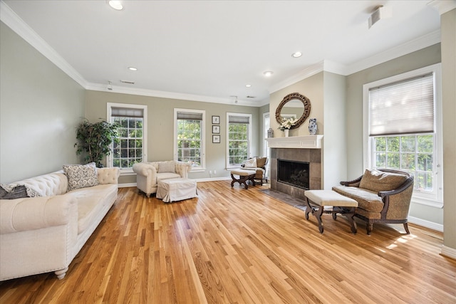 3388 Maroneal St, Houston, TX 77025 - living area featuring light wood-type flooring, a tiled fireplace, baseboards, plenty of natural light, and recessed lighting