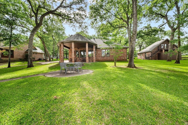 123 June Blvd, Streetman, TX 75859 - view of green lawn with a gazebo, stairway, and a patio