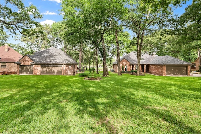 123 June Blvd, Streetman, TX 75859 - view of grassy yard featuring a garage