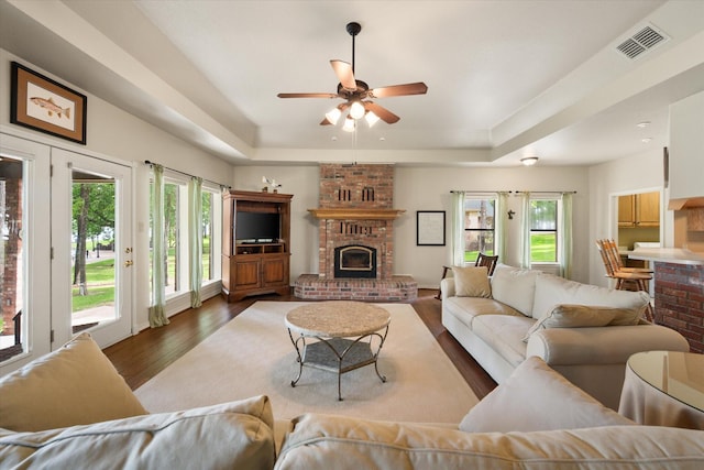 123 June Blvd, Streetman, TX 75859 - living room with a tray ceiling, plenty of natural light, and wood finished floors