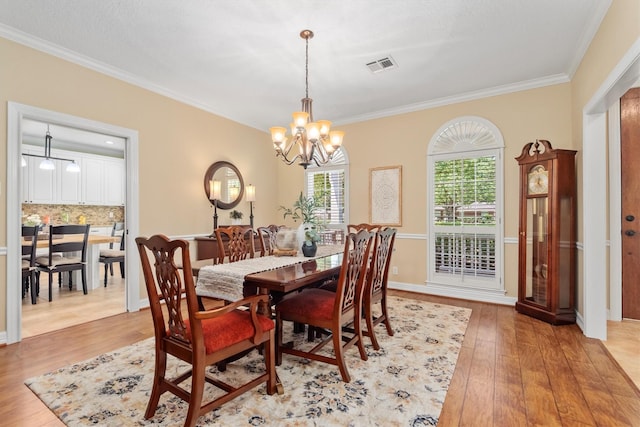 18106 E Cypress Hill Cir, Cypress, TX 77433 - dining room featuring crown molding, a chandelier, and light wood-style flooring