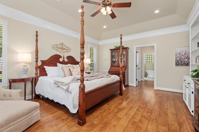 18106 E Cypress Hill Cir, Cypress, TX 77433 - bedroom featuring baseboards, light wood-style floors, ornamental molding, a tray ceiling, and ensuite bathroom