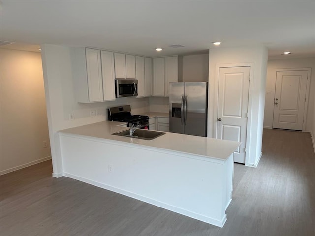 315 Brandi Dr, Wharton, TX 77488 - kitchen featuring appliances with stainless steel finishes, a sink, light wood finished floors, baseboards, and recessed lighting