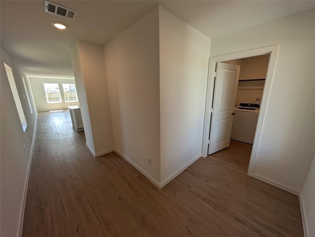 315 Brandi Dr, Wharton, TX 77488 - hall with washer / dryer, wood finished floors, baseboards, and recessed lighting