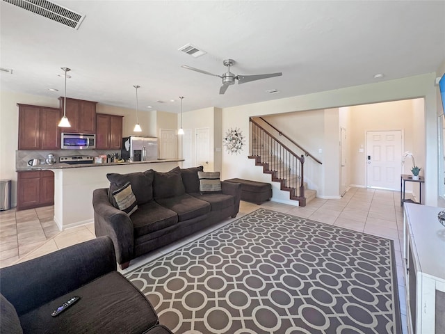 2822 Windy Thicket Ln, Houston, TX 77082 - living area featuring light tile patterned flooring, stairway, and ceiling fan
