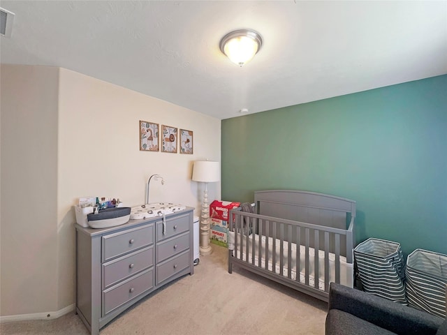 2822 Windy Thicket Ln, Houston, TX 77082 - bedroom featuring light carpet, baseboards, and a crib