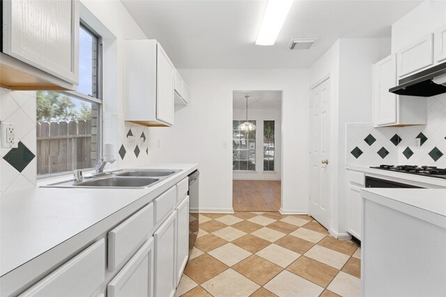 6414 Windmist Cir, Houston, TX 77084 - kitchen featuring light countertops, decorative backsplash, gas cooktop, dishwasher, and under cabinet range hood