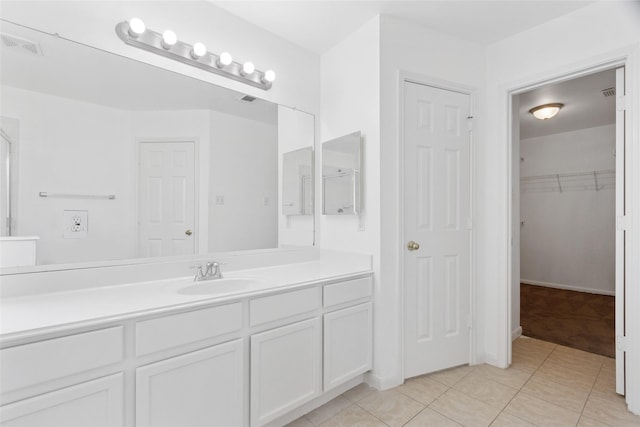 6414 Windmist Cir, Houston, TX 77084 - bathroom with vanity, tile patterned floors, and a walk in closet