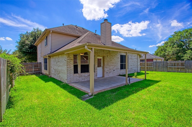 6414 Windmist Cir, Houston, TX 77084 - back of property with a chimney, brick siding, a patio area, and roof with shingles