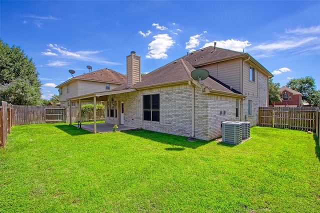 6414 Windmist Cir, Houston, TX 77084 - back of house with a patio area, a chimney, central air condition unit, brick siding, and roof with shingles