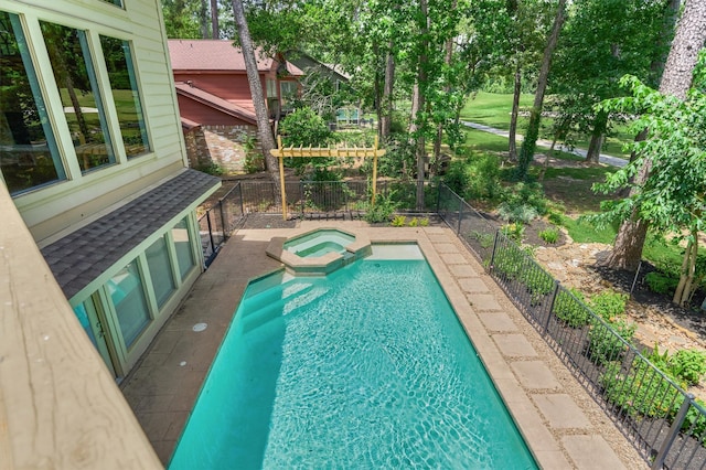 view of pool with a fenced backyard, a pool with connected hot tub, view of scattered trees, and a patio