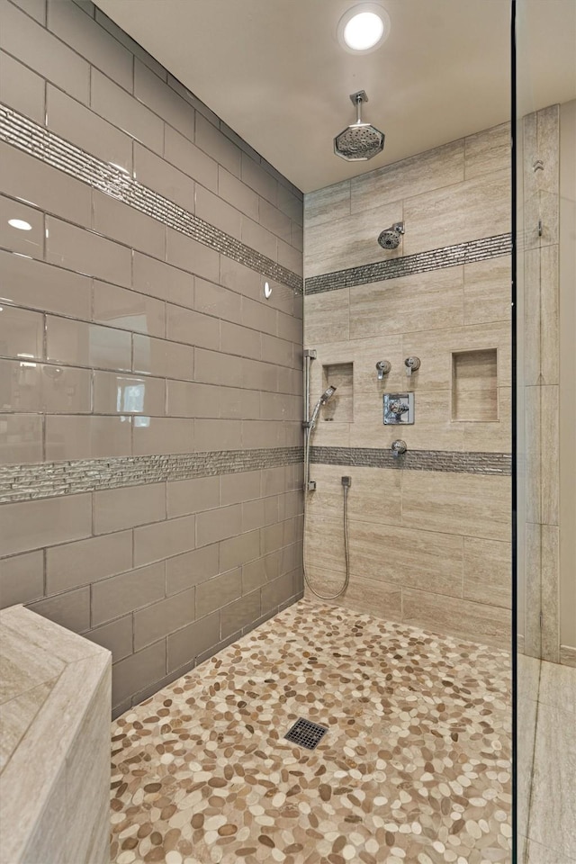 bathroom featuring a tile shower