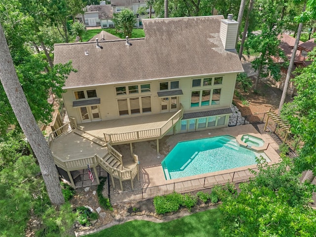 rear view of property with a chimney, a patio, stairs, and a fenced backyard