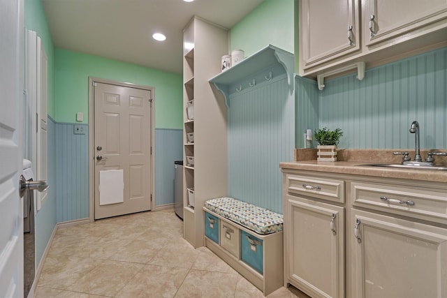 mudroom with a sink, light tile patterned floors, and recessed lighting