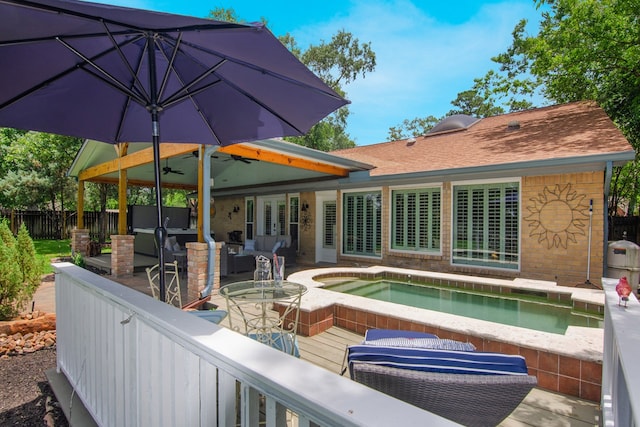 10022 Jan Glen Ln, Houston, TX 77070 - back of house featuring outdoor lounge area, an outdoor hot tub, fence, a ceiling fan, and brick siding
