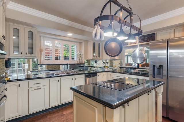 10022 Jan Glen Ln, Houston, TX 77070 - kitchen with appliances with stainless steel finishes, ornamental molding, glass insert cabinets, a sink, and dark wood finished floors