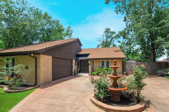 10022 Jan Glen Ln, Houston, TX 77070 - view of front of property featuring brick siding, fence, an attached garage, and roof with shingles