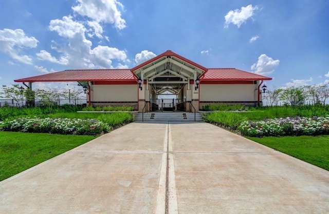 2338 Vanessa Cay Ln, La Porte, TX 77571 - view of front of property with metal roof, a front lawn, and stucco siding