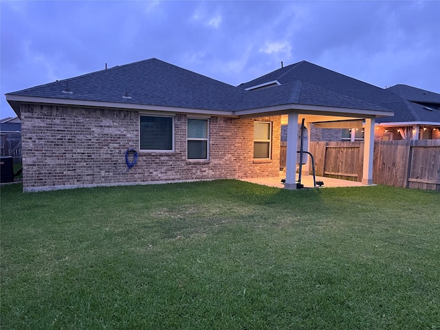 2338 Vanessa Cay Ln, La Porte, TX 77571 - rear view of property with a shingled roof, a patio, central AC unit, and brick siding