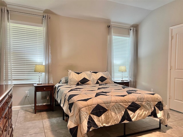2338 Vanessa Cay Ln, La Porte, TX 77571 - bedroom featuring vaulted ceiling, light tile patterned flooring, and baseboards
