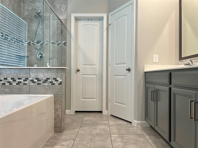 2338 Vanessa Cay Ln, La Porte, TX 77571 - full bathroom with a shower stall, tile patterned flooring, a garden tub, vanity, and baseboards