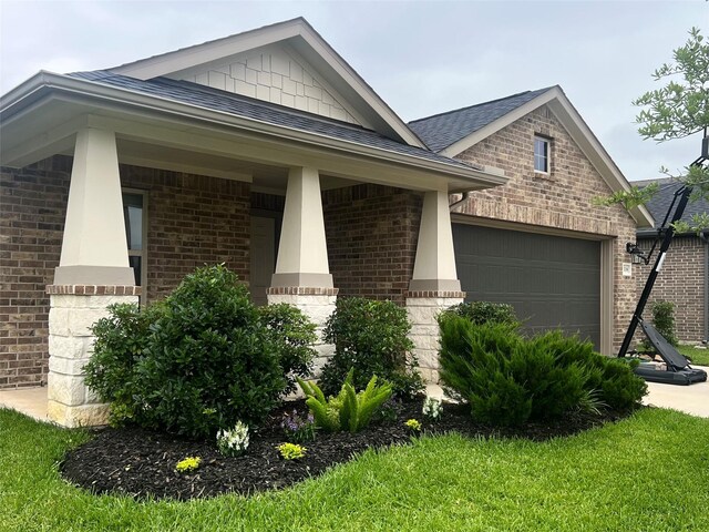 2338 Vanessa Cay Ln, La Porte, TX 77571 - view of side of property with brick siding, a garage, a shingled roof, and covered porch