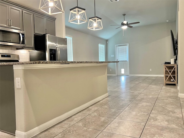 2338 Vanessa Cay Ln, La Porte, TX 77571 - kitchen featuring appliances with stainless steel finishes, gray cabinets, ceiling fan, tasteful backsplash, and dark stone counters
