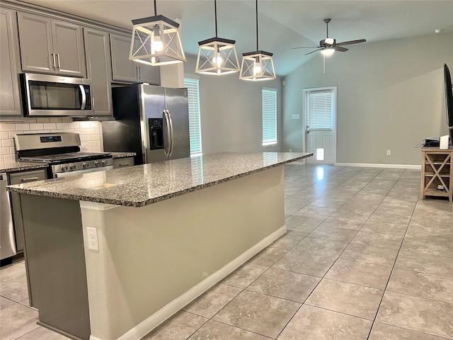 2338 Vanessa Cay Ln, La Porte, TX 77571 - kitchen featuring appliances with stainless steel finishes, gray cabinets, ceiling fan, light tile patterned flooring, and vaulted ceiling