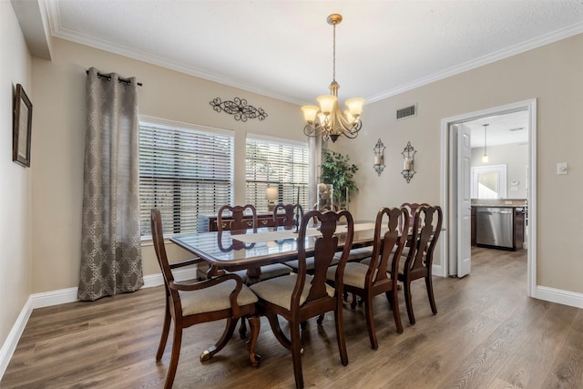 17326 Meadow Heights Dr, Houston, TX 77095 - dining area with a chandelier, wood finished floors, ornamental molding, and baseboards