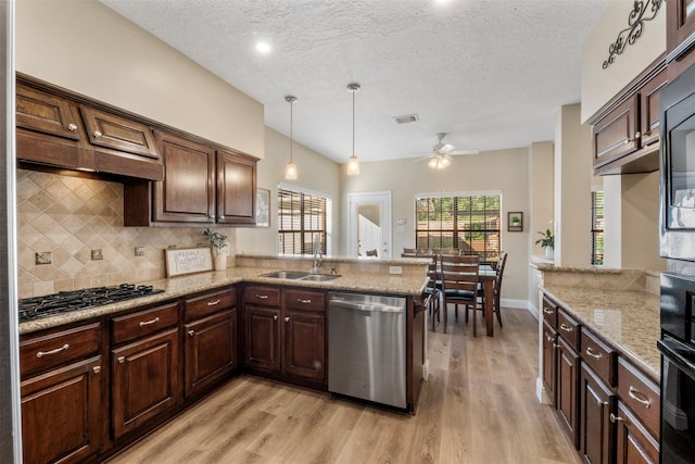 17326 Meadow Heights Dr, Houston, TX 77095 - kitchen with stainless steel dishwasher, a sink, gas cooktop, a ceiling fan, and backsplash