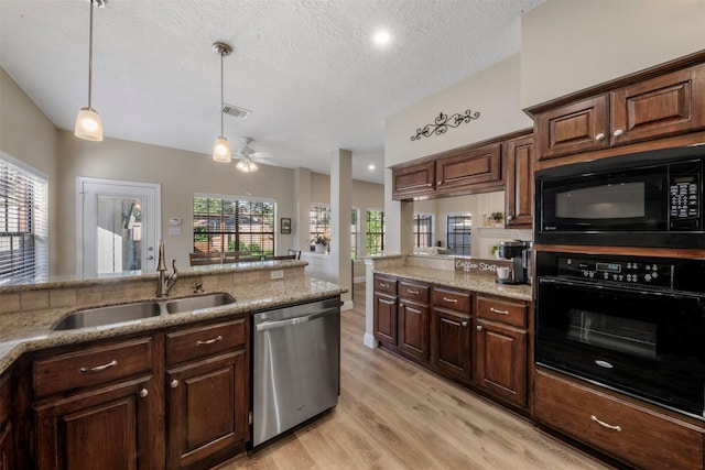17326 Meadow Heights Dr, Houston, TX 77095 - kitchen featuring black appliances, a sink, light wood-style flooring, decorative light fixtures, and light stone counters