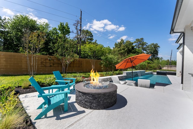 view of patio with an outdoor fire pit and a fenced backyard