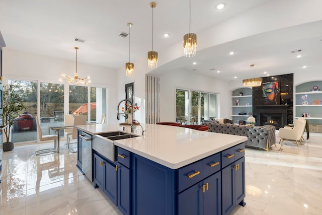 kitchen featuring a chandelier, blue cabinetry, stainless steel dishwasher, a sink, and light marble finish floors
