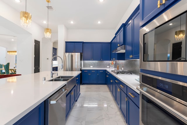 kitchen with stainless steel appliances, a sink, blue cabinets, light marble finish flooring, and recessed lighting