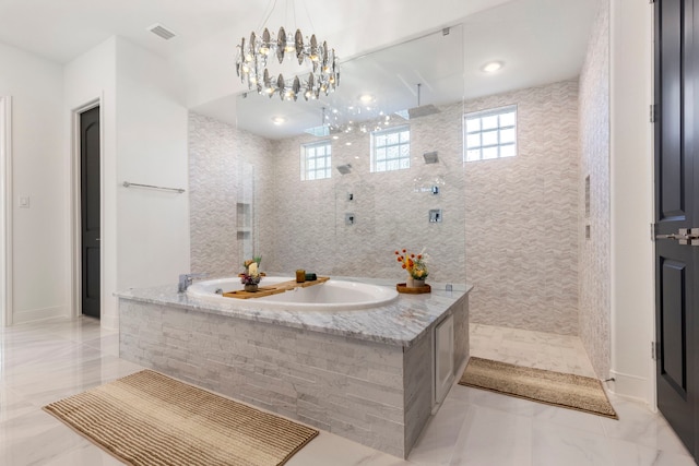 full bath with a garden tub, walk in shower, tile patterned flooring, and a chandelier