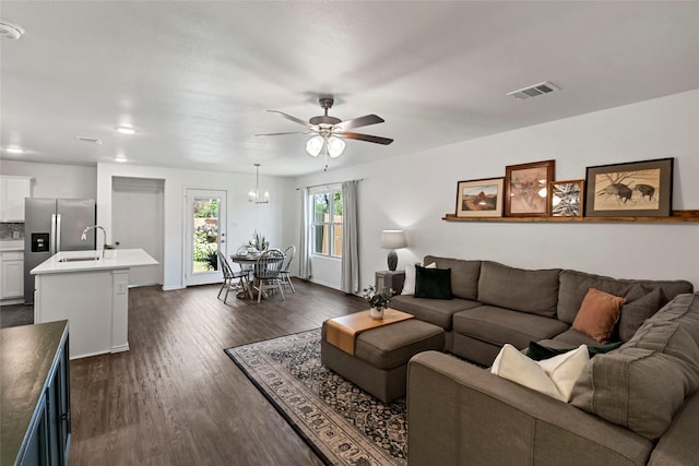 2117 Heritage Meadow Ln, Bryan, TX 77803 - living room with ceiling fan, dark wood-style flooring, a chandelier, and baseboards