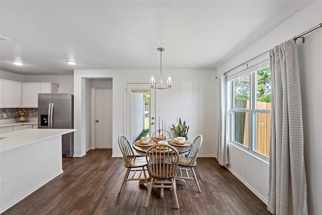 2117 Heritage Meadow Ln, Bryan, TX 77803 - dining room featuring dark wood-type flooring, baseboards, and a chandelier