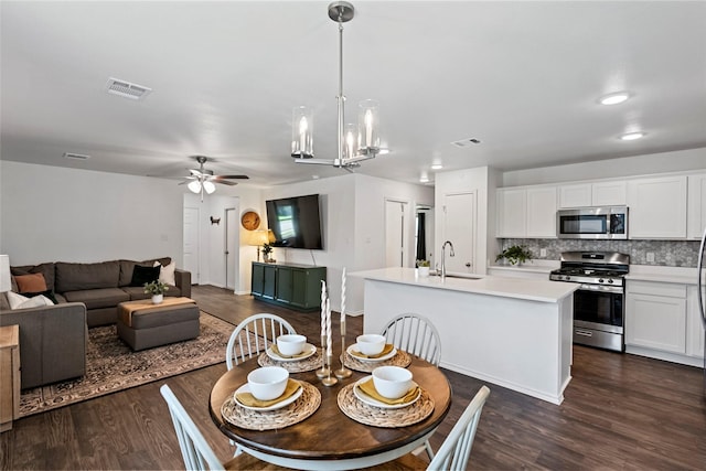 2117 Heritage Meadow Ln, Bryan, TX 77803 - dining room featuring a ceiling fan, dark wood finished floors, and a chandelier