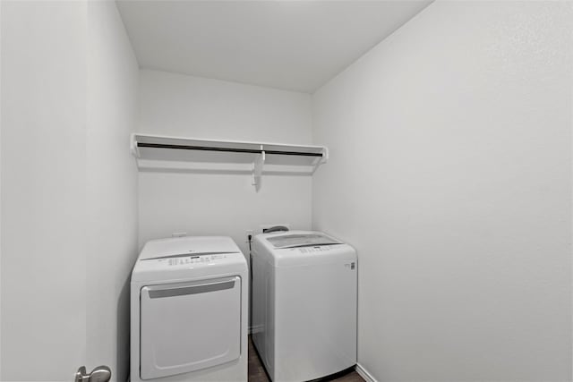 2117 Heritage Meadow Ln, Bryan, TX 77803 - washroom with washer and dryer and wood finished floors