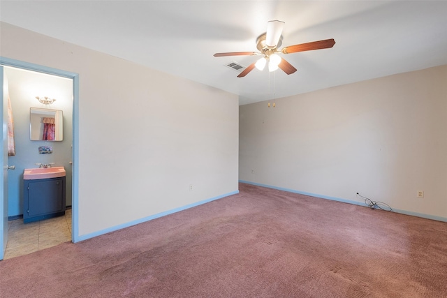 6046 Harbrook Dr, Houston, TX 77087 - spare room featuring a sink, light colored carpet, ceiling fan, and baseboards