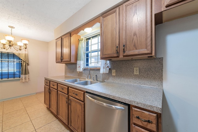 6046 Harbrook Dr, Houston, TX 77087 - kitchen featuring stainless steel dishwasher, freestanding refrigerator, a sink, a chandelier, and decorative backsplash