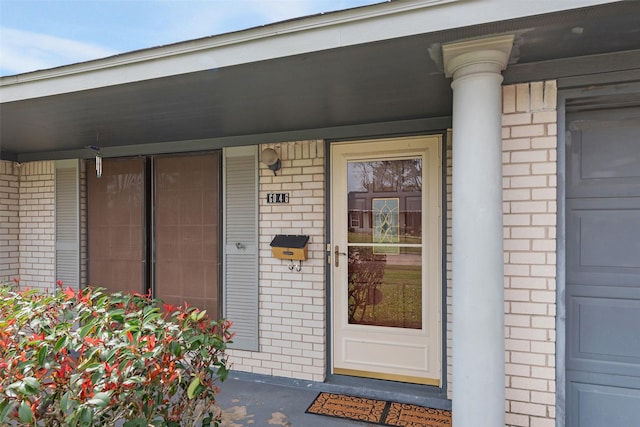 6046 Harbrook Dr, Houston, TX 77087 - doorway to property featuring brick siding and a porch