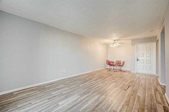 2818 S Bartell Dr Unit 39, Houston, TX 77054 - unfurnished room with light wood finished floors, ceiling fan, baseboards, and a textured ceiling
