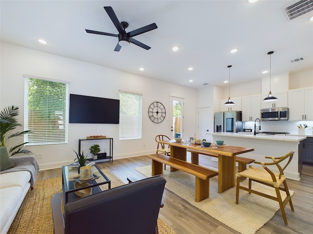 5808 Highland Sky Ln, Houston, TX 77091 - living room with ceiling fan, baseboards, recessed lighting, and light wood-style floors