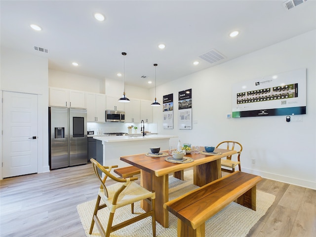 5808 Highland Sky Ln, Houston, TX 77091 - dining area with light wood finished floors, recessed lighting, and baseboards