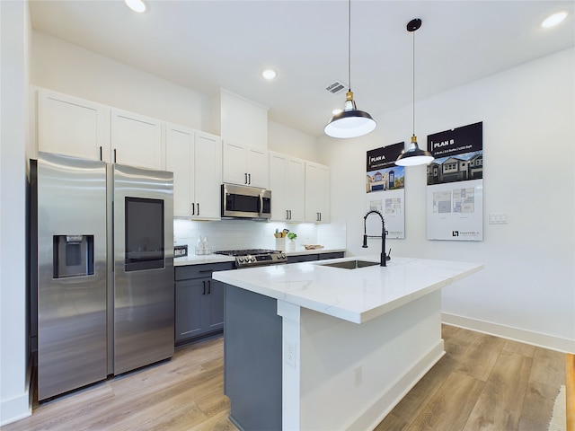 5808 Highland Sky Ln, Houston, TX 77091 - kitchen featuring stainless steel appliances, a sink, light wood-style flooring, tasteful backsplash, and recessed lighting