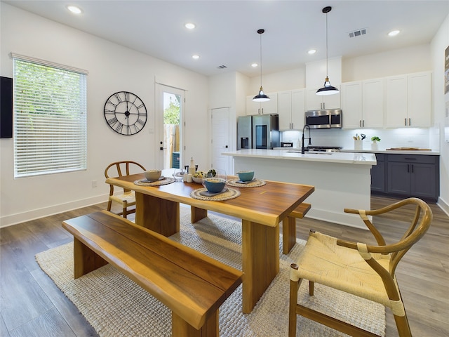 5808 Highland Sky Ln, Houston, TX 77091 - dining space with light wood finished floors, recessed lighting, and baseboards