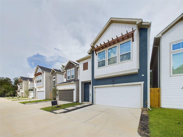 5808 Highland Sky Ln, Houston, TX 77091 - townhome / multi-family property featuring board and batten siding, an attached garage, concrete driveway, and a residential view
